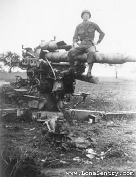 [GI of 3rd Armd. Div. with Abandoned German Flak]