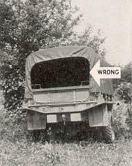 [FIGURE 30 (1) and (2). Wrong. The characteristic black shadow in the open end of a cargo truck can be seen for a considerable distance. One way to conceal this shadow is to drop the rear tarpaulin.  Another way is to use natural materials, as shown here.]