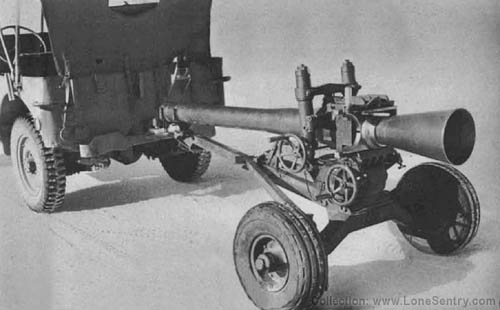 [HOWITZER, 105-mm, T9 and CARRIAGE, T9 in traveling position behind 1/4 ton 4x4 truck]