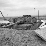 A knocked-out German Panzer IV tank dug into a hull-down position in Normandy during summer of 1944.