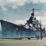 USS Minneapolis (CA-36), a U.S. Navy New Orleans-class heavy cruiser, is docked at Pearl Harbor Navy Yard, Hawaii in April 1943 after repairs. (U.S. Navy Photograph.)